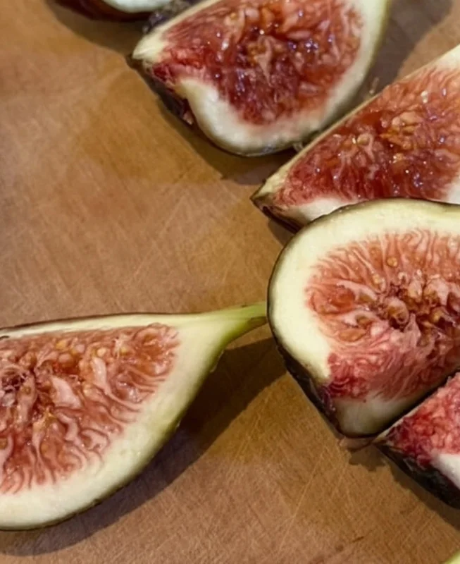 Fresh fig quarters on a wooden board